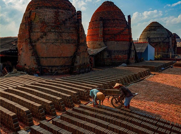 Worker outside kiln red ceramic
